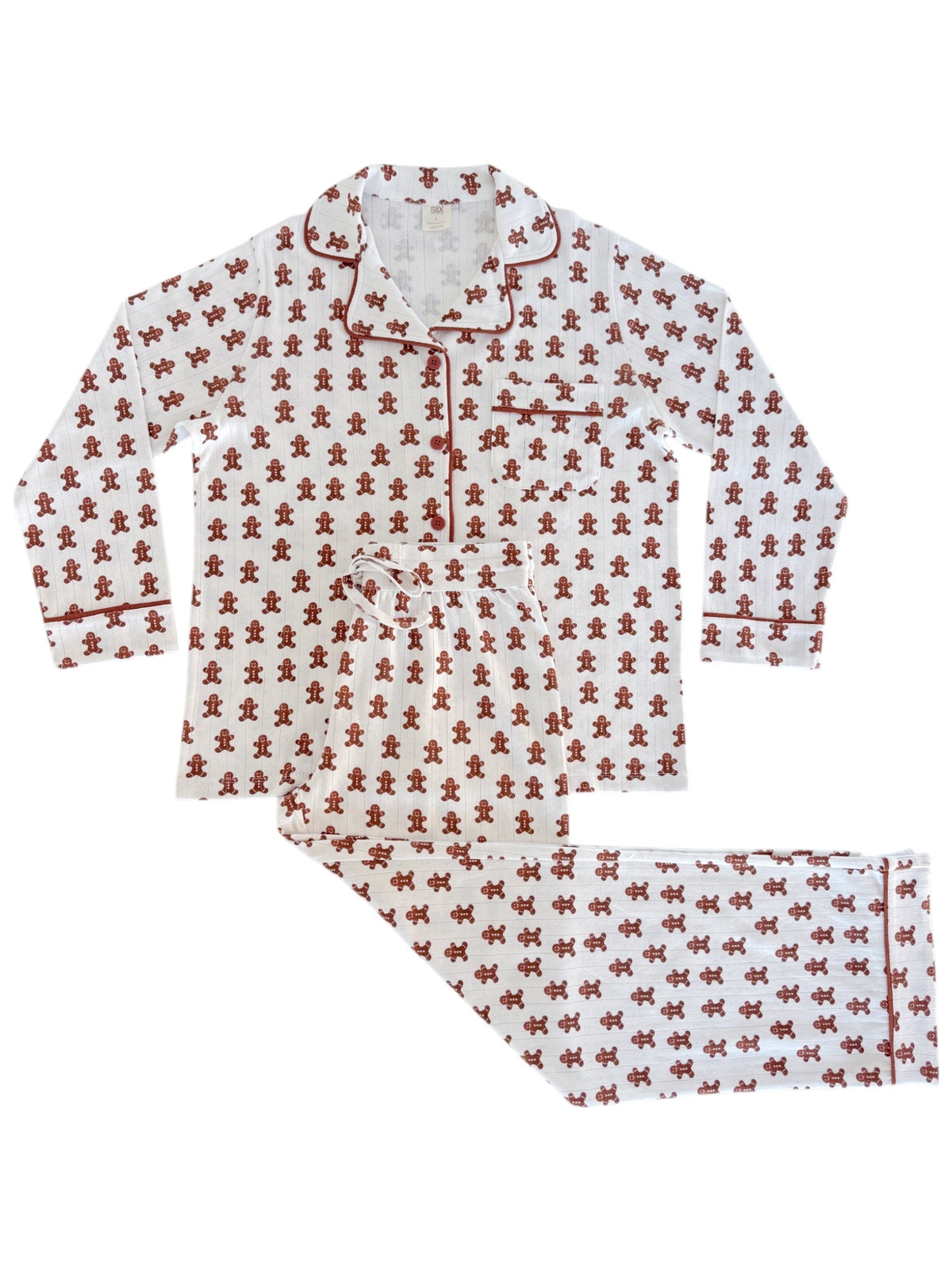 White pajama set with red gingerbread man pattern, featuring long sleeves and pants.