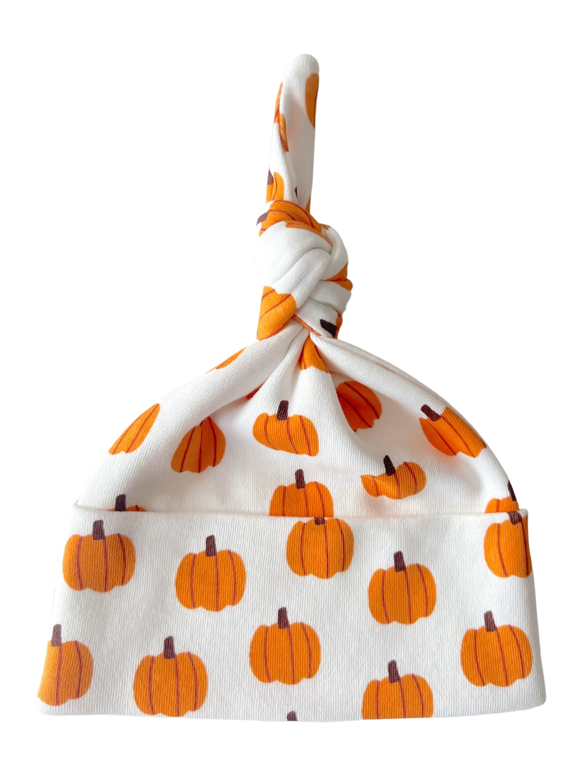 White baby hat with orange pumpkin patterns and a knotted top. Perfect for fall or Halloween.