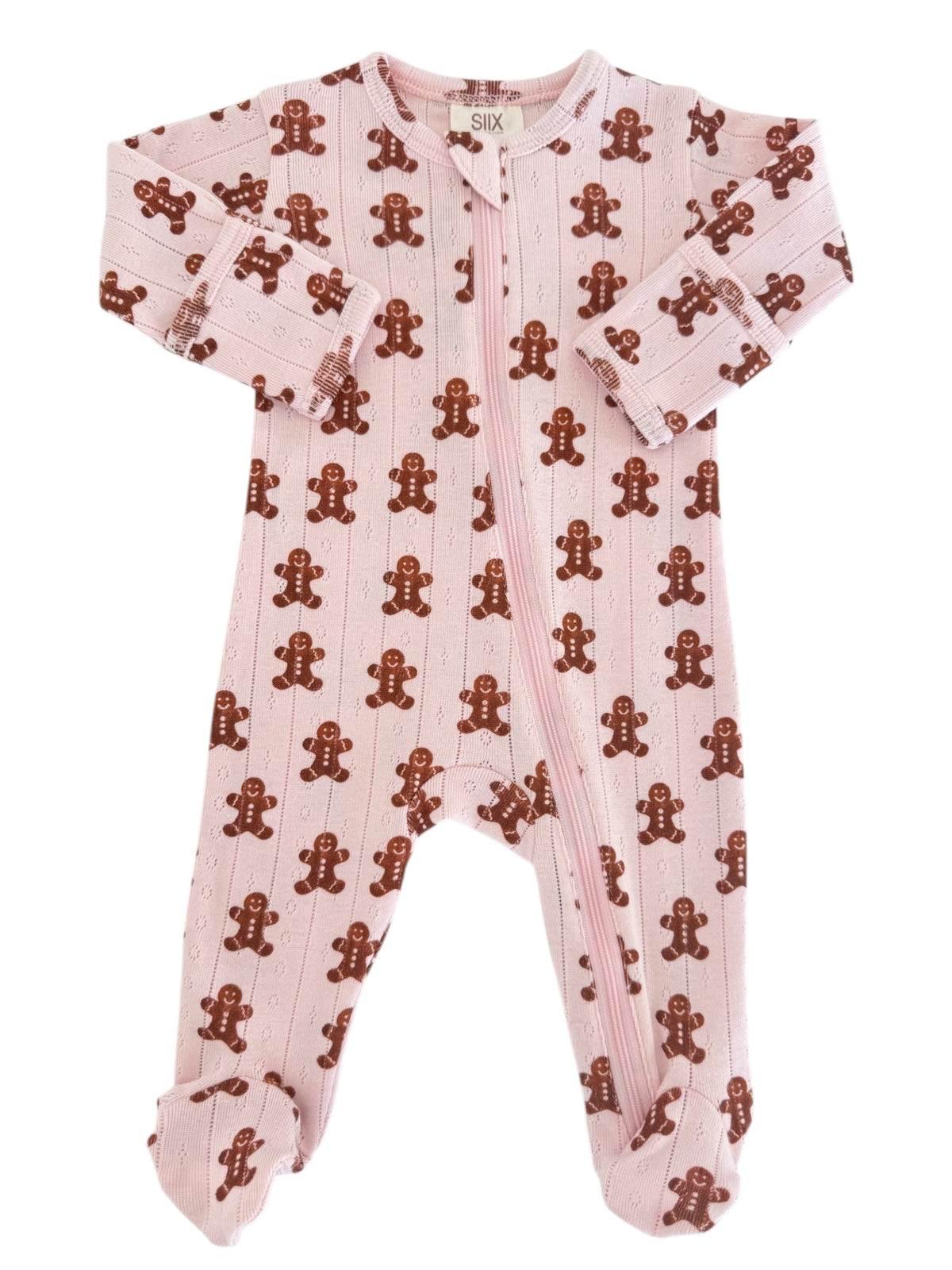 Pink one-piece baby pajamas featuring brown gingerbread man pattern. Zipper closure for easy dressing.