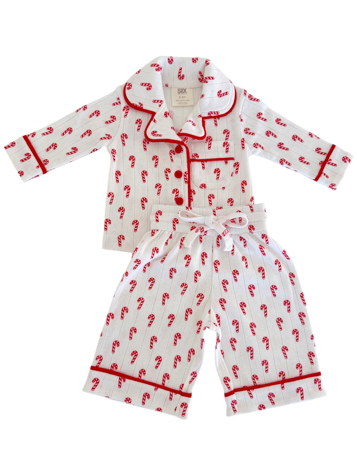 White pajama set with red candy cane design, featuring a collar and contrasting trim.