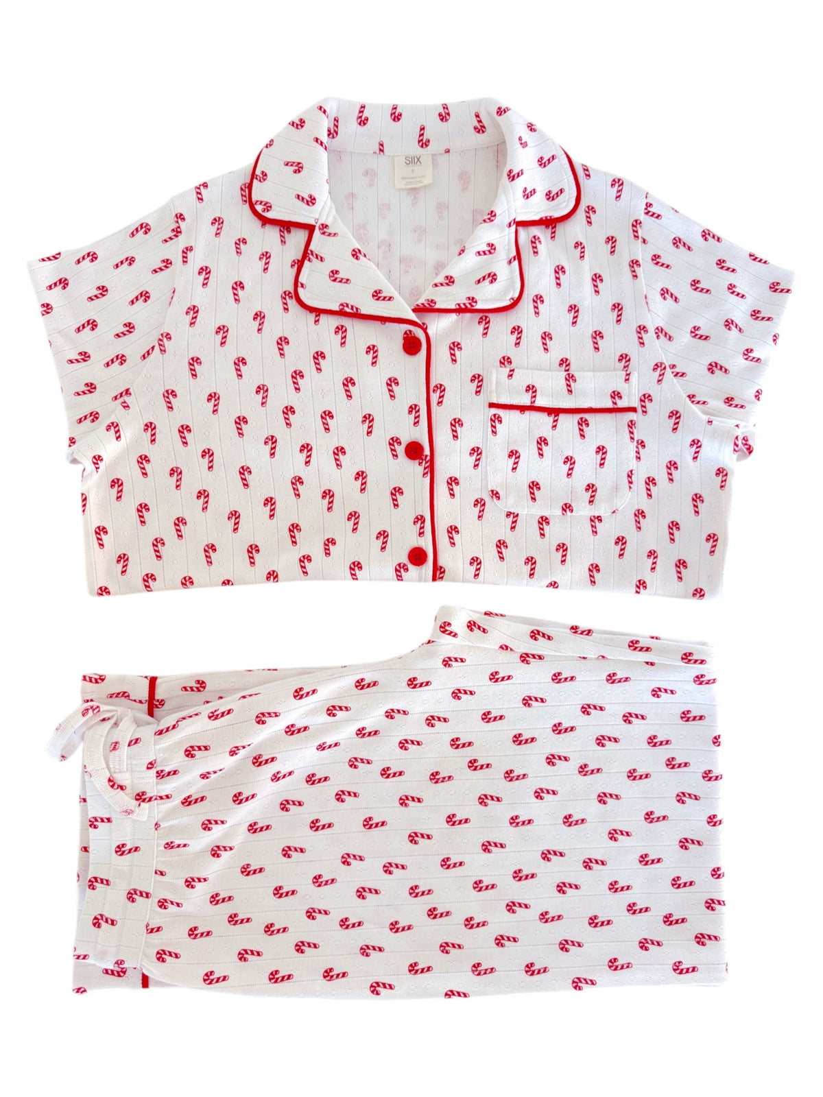 Red and white candy cane patterned pajama set featuring a short-sleeve top and shorts.
