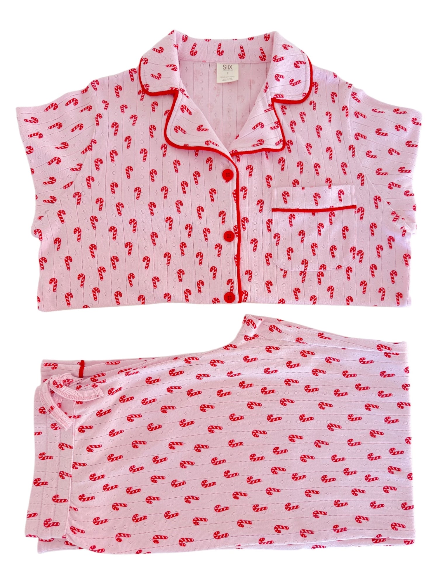 Pink pajama set with red candy cane patterns, featuring a short-sleeved top and matching pants.