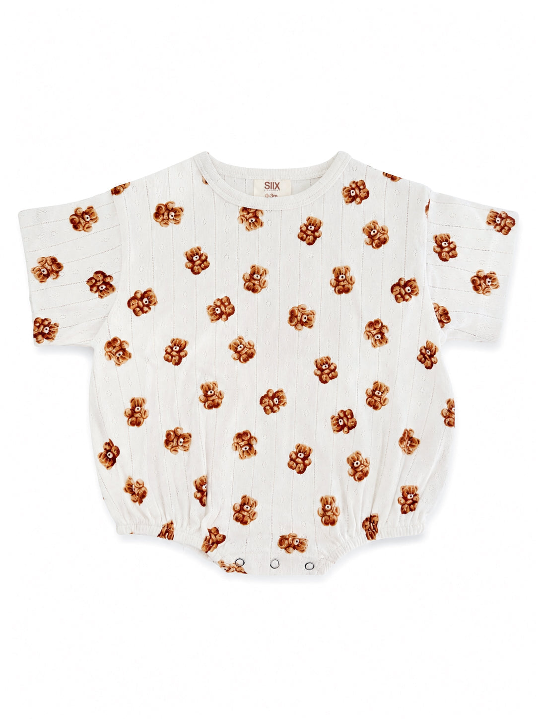 White baby romper with a playful bear print pattern, featuring short sleeves and snap closures.