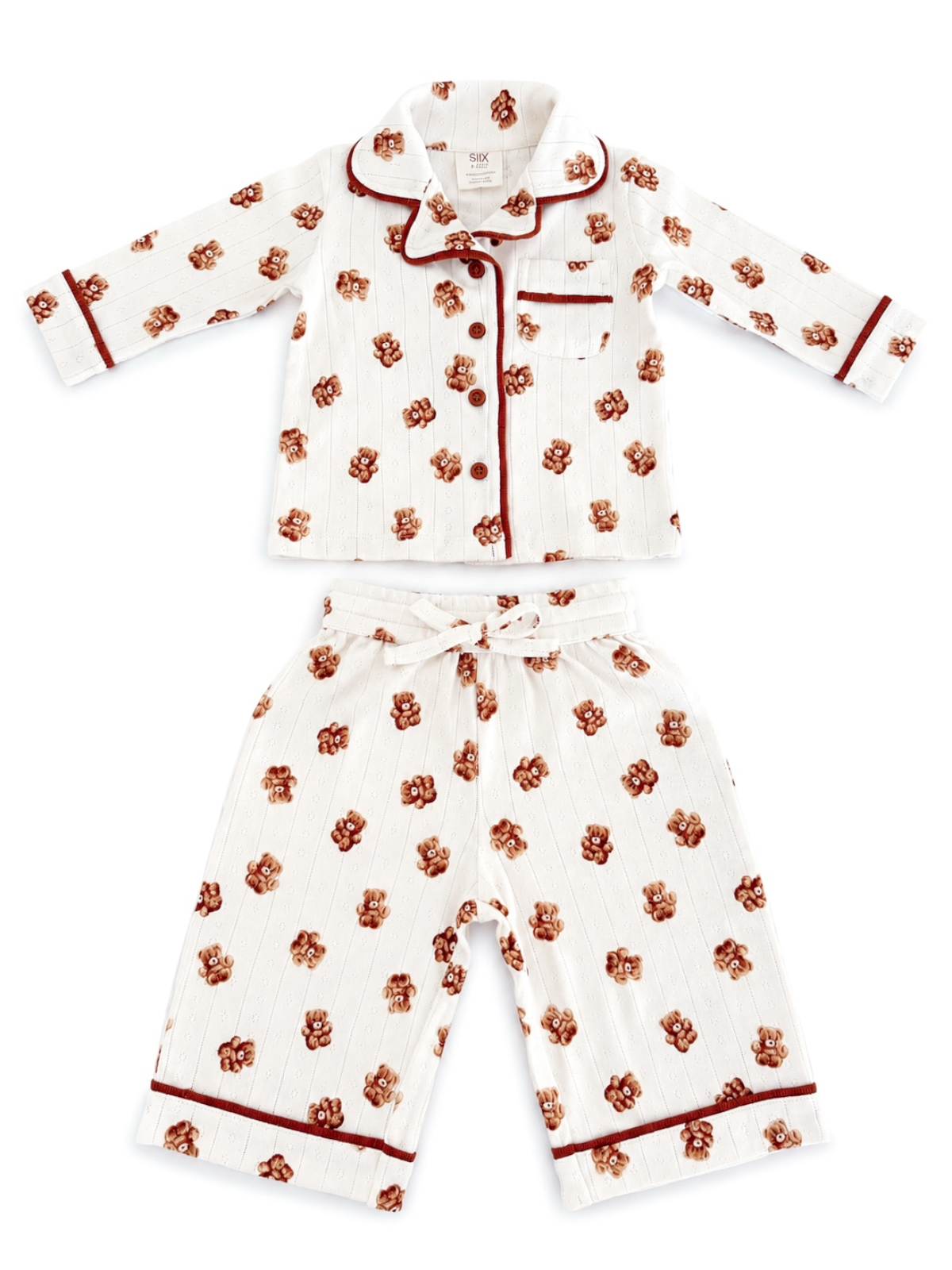 Kids' white pajama set with bear prints, featuring a button-up top and drawstring pants with red accents.