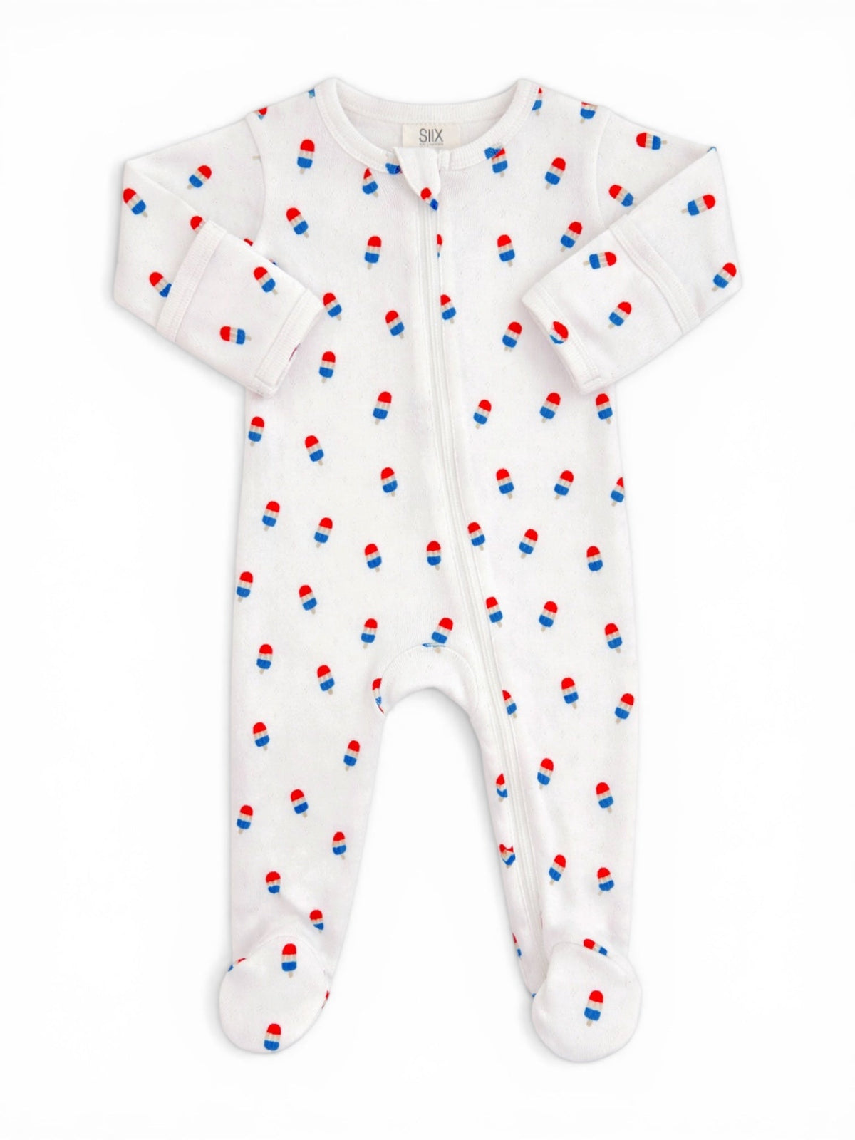 White baby onesie with red and blue pill print, featuring a front zipper and footed design.