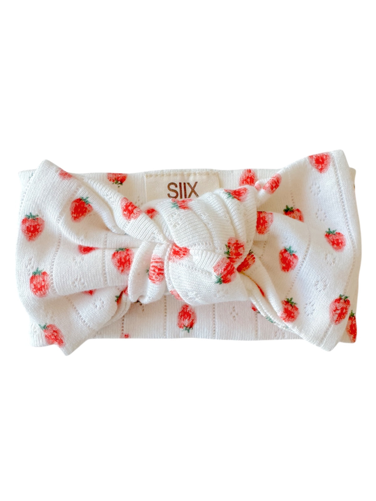 White headband with red strawberries, featuring a large knot at the front for a playful and stylish accessory.