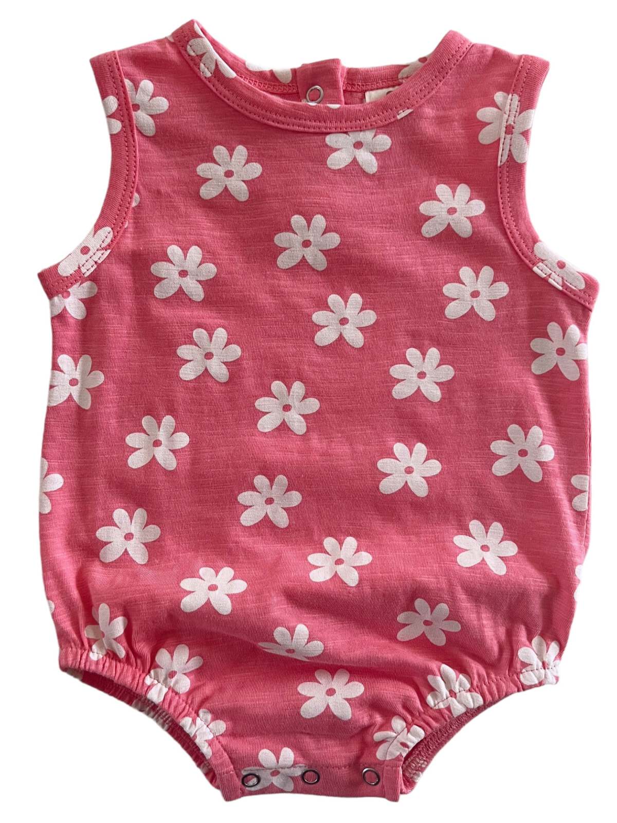 Pink floral baby onesie with white daisies, sleeveless design and snap closure at the bottom.