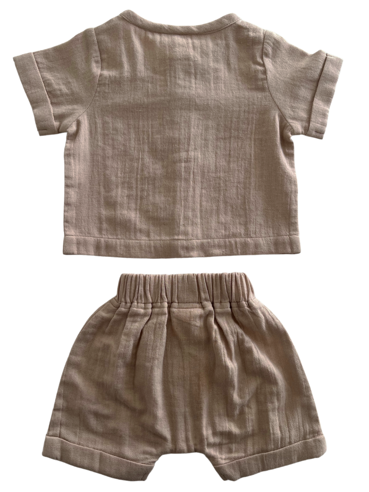 Light beige toddler outfit consisting of a short-sleeve top and matching shorts, displayed flat.