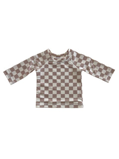 Brown and cream checkered long-sleeve children's swim shirt on a white background.