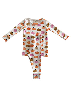 White pajama set featuring colorful pumpkin patterns in orange, pink, and brown hues.