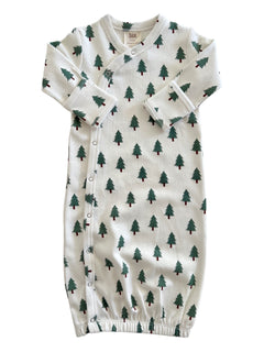 White newborn gown with green tree patterns, featuring snap buttons and elastic at the bottom.