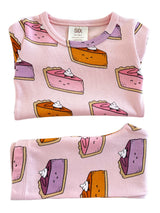 Pink toddler shirt featuring cartoon slices of cake with whipped cream, in sizes 12-18 months.