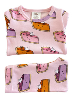 Pink toddler shirt featuring cartoon slices of cake with whipped cream, in sizes 12-18 months.