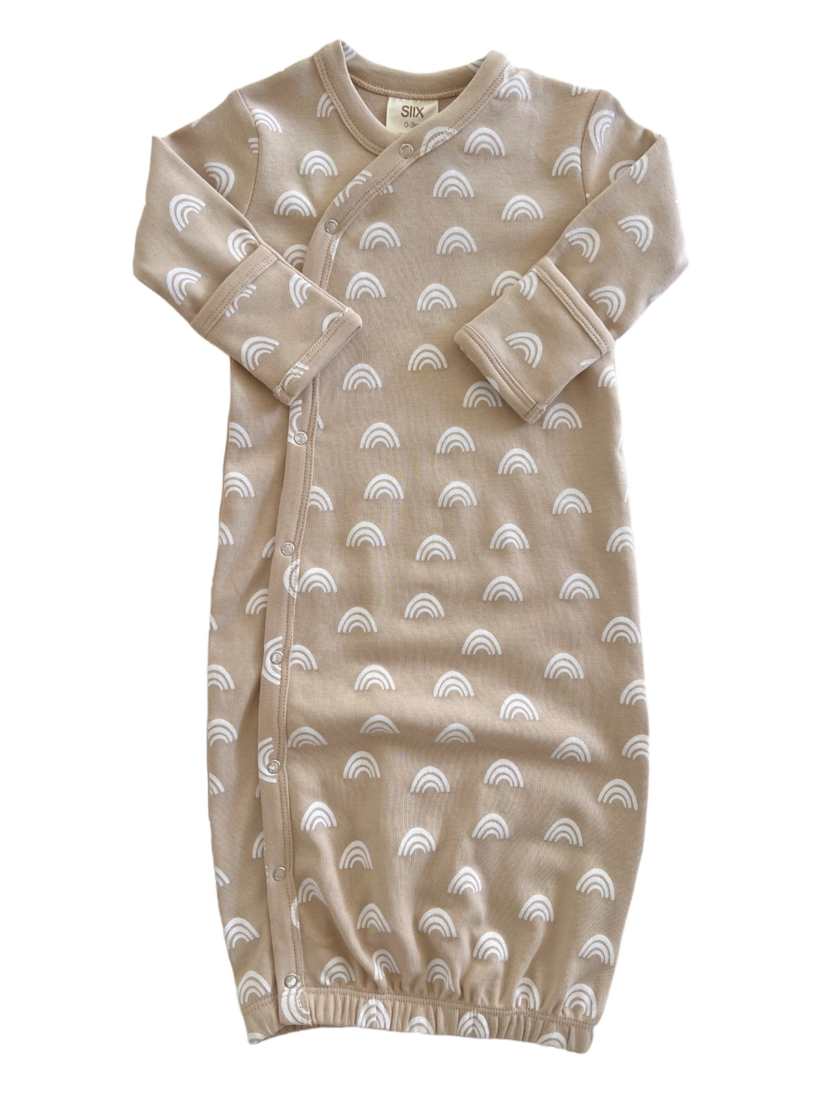 Beige baby gown with white rainbow patterns and snap closures, featuring long sleeves and a cinched bottom.