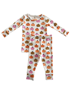 Children's pajama set featuring a playful pumpkin pattern in various colors on a white background.