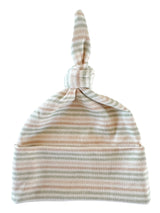 Striped baby hat with a knotted top, featuring soft pastel colors of pink, green, and cream.