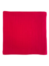 Red knitted blanket with a textured pattern of vertical lines and small flowers.