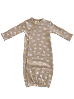 Beige baby gown with white rainbow patterns and long sleeves, featuring snap closures for easy dressing.