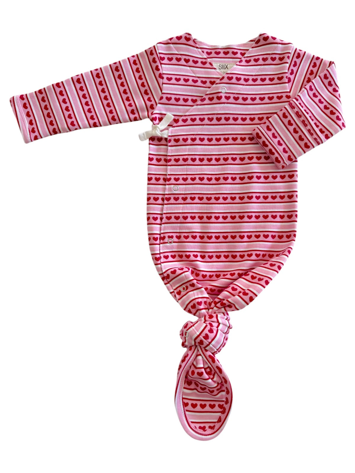 Pink baby gown with red heart patterns, featuring long sleeves and a knotted bottom for easy dressing.