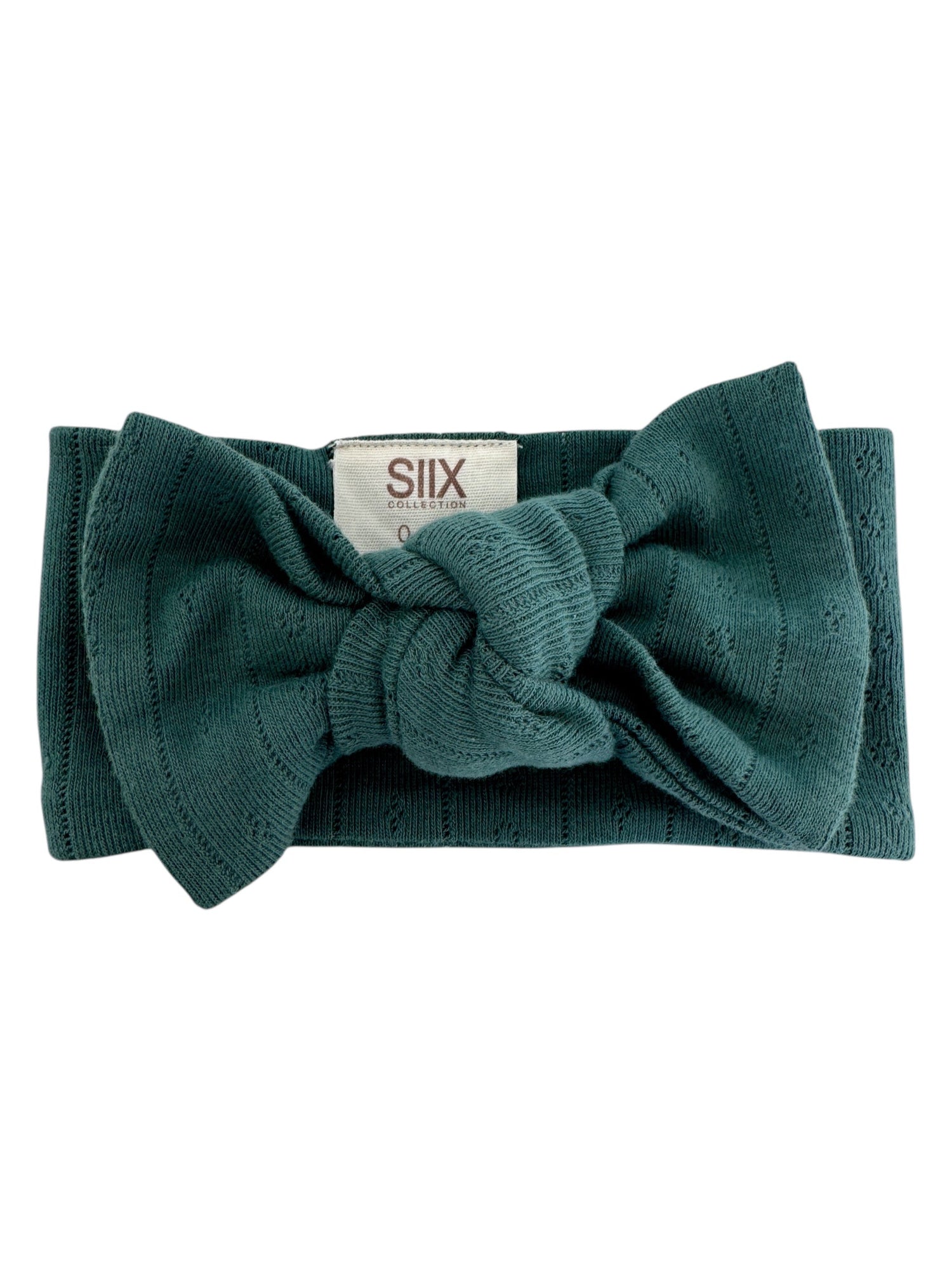 Teal knit headband with a bow and a tag reading 