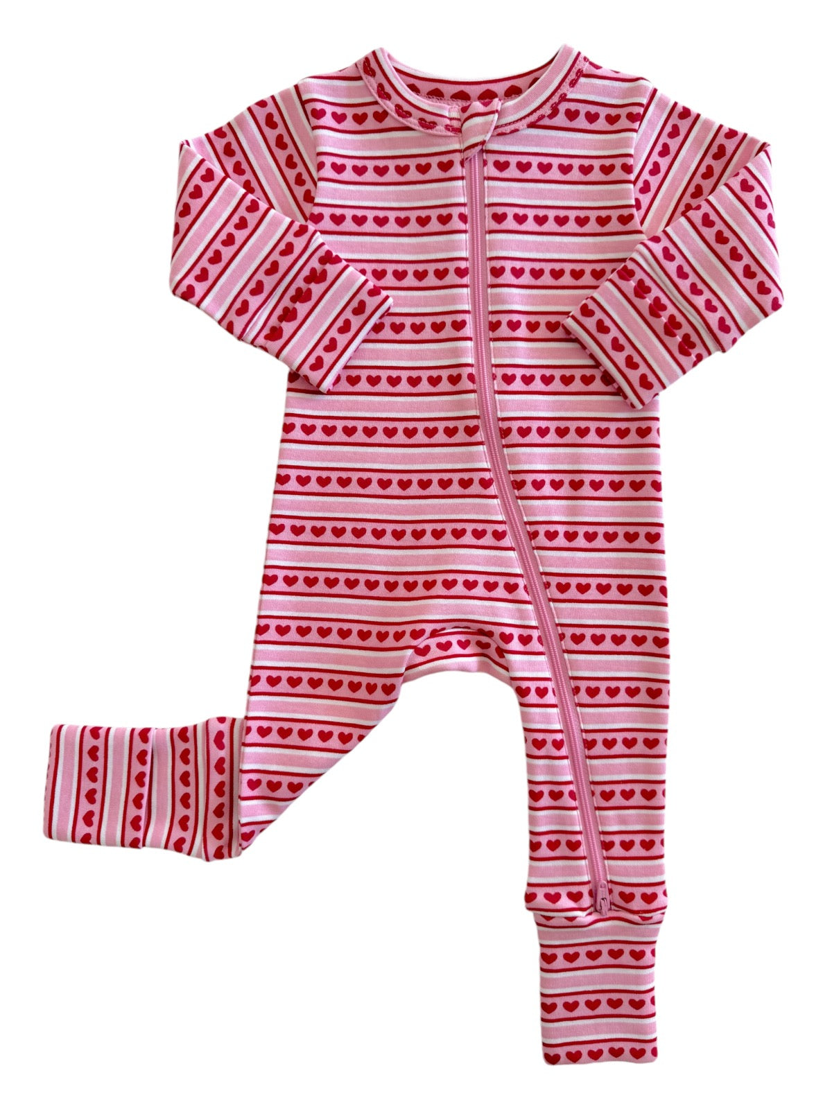 Pink baby onesie with red heart patterns and a zipper in the front. Ideal for cozy, stylish infant wear.
