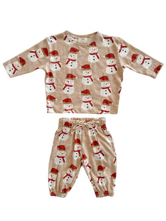 Children's winter outfit featuring a snowman-patterned top and matching pants in soft beige fabric.