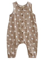 Tan children's romper with white sun patterns and wooden buttons down the front.