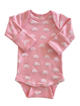 Pink baby onesie with white rainbow patterns, featuring long sleeves and snap closure at the bottom.