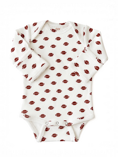 White baby onesie with football print pattern in brown and red, long sleeves and snap button closure.