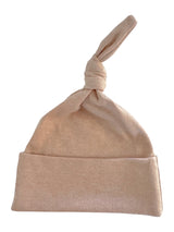 Light beige knotted baby hat with a soft, stretchy fabric and a rolled cuff. Ideal for newborns.