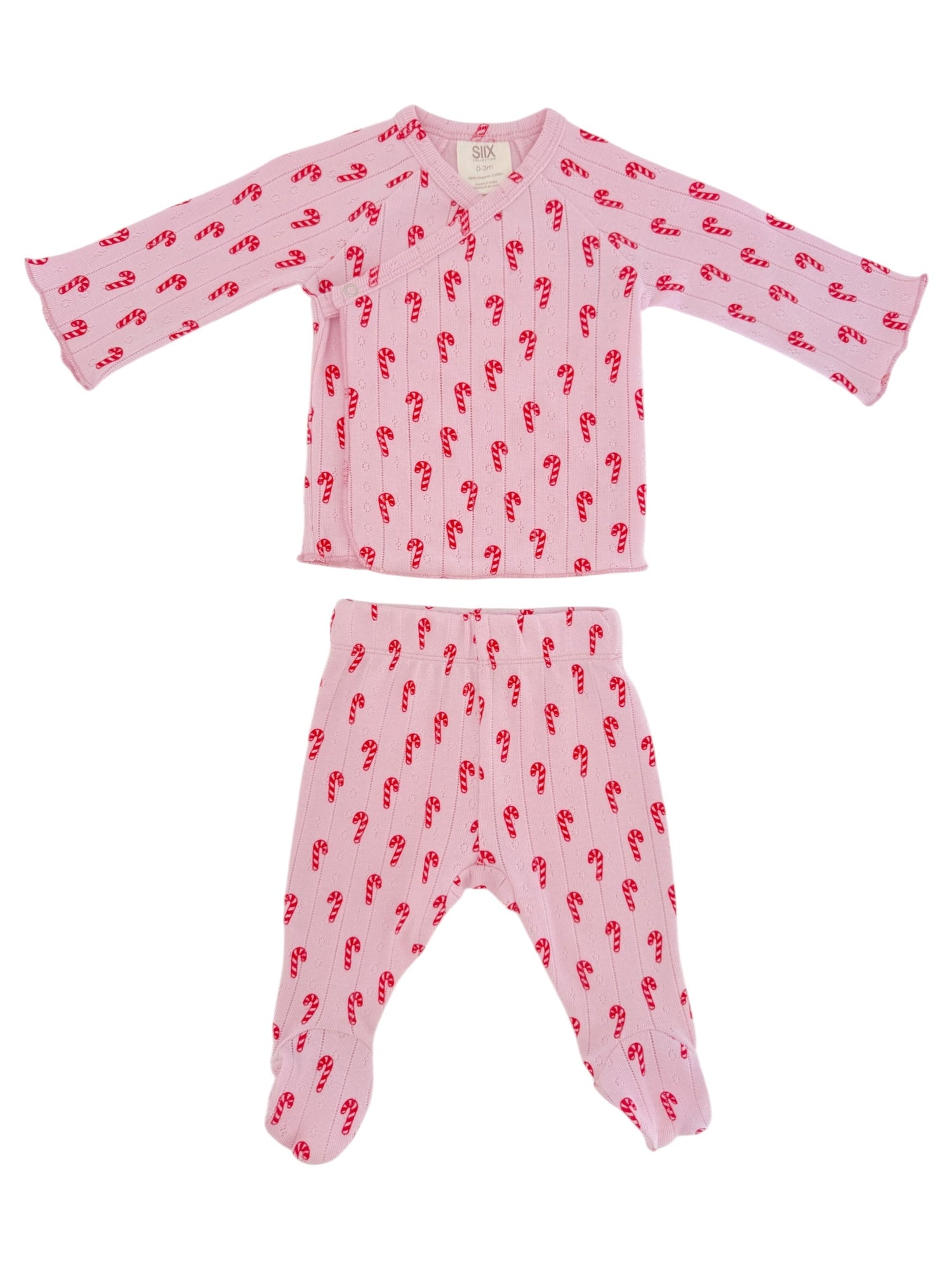 Pink pajama set with candy cane pattern; includes long-sleeved top and matching footed pants.