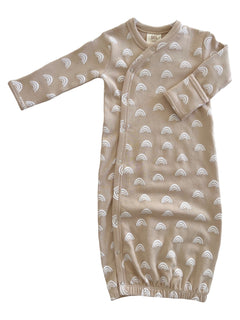 Tan baby gown with white rainbow patterns and snap buttons, designed for comfort and easy diaper changes.