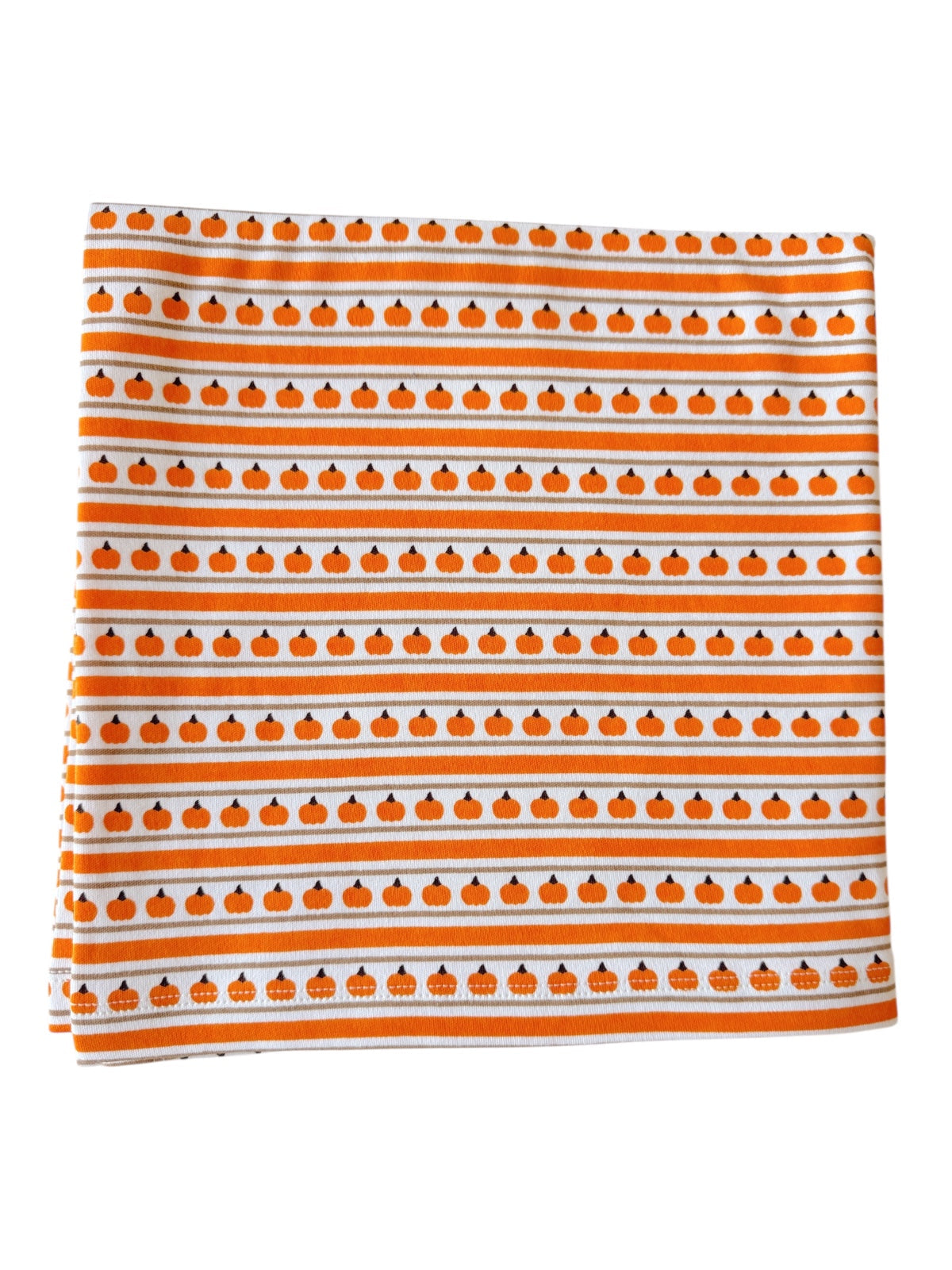 Orange and white fabric featuring repeating pumpkin patterns in horizontal stripes. Perfect for fall decor.