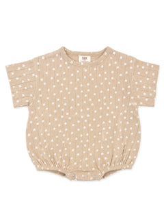 Tan baby romper with white floral print and short sleeves, featuring gathered bottom and snap closures.