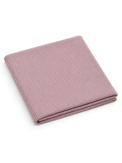 Folded ribbed fabric in a soft mauve color, ideal for home decor or bedding.