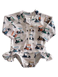 Children's rash guard swimsuit with golf cart print and ruffle detail, ideal for sun protection and beach fun.
