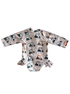 Child's long-sleeve swimsuit featuring colorful golf cart patterns on a white background.