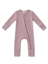 Light mauve baby onesie with long sleeves and a front zipper, featuring ribbed texture.