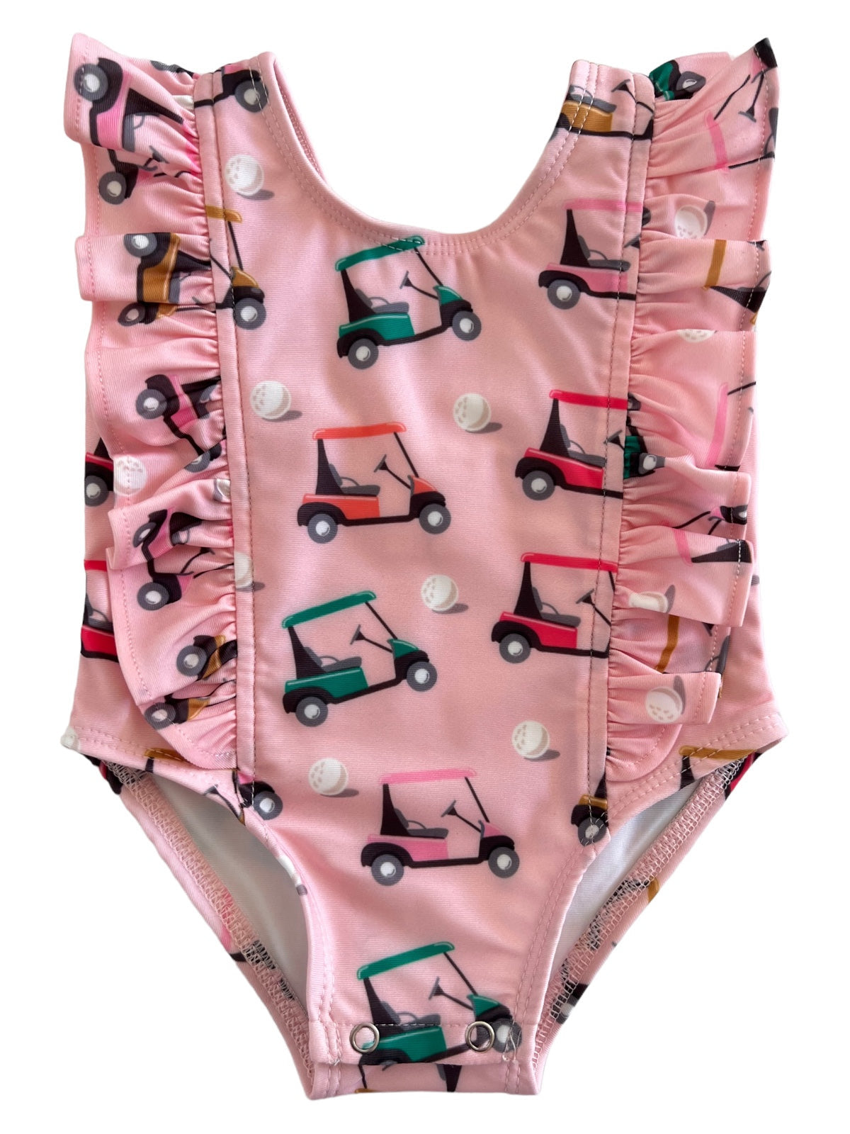 Pink ruffled swimsuit featuring colorful golf cart and golf ball patterns, ideal for summer fun.