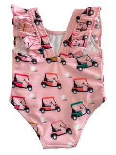 Pink bathing suit with ruffled straps, featuring playful golf cart and ball patterns. Perfect for summer fun.