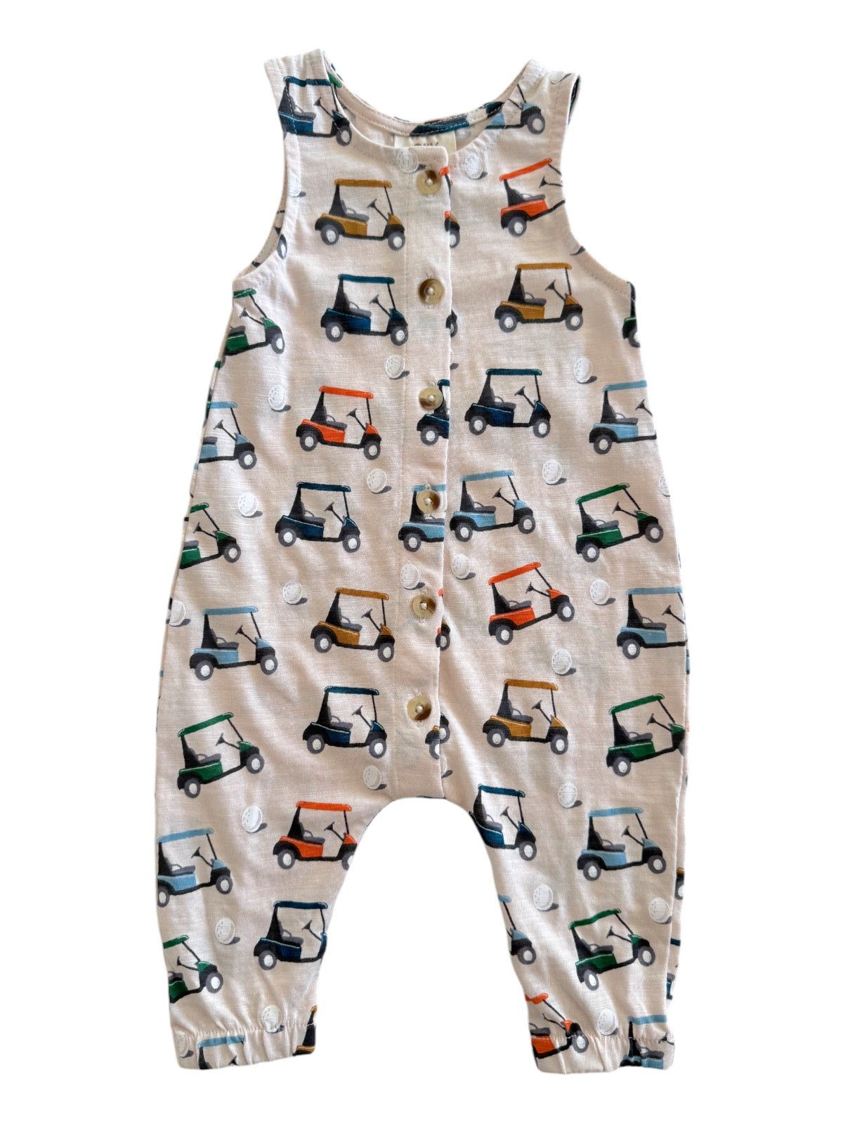 Tan romper with a golf cart print and buttons, perfect for young children. Great for casual outings or playtime.