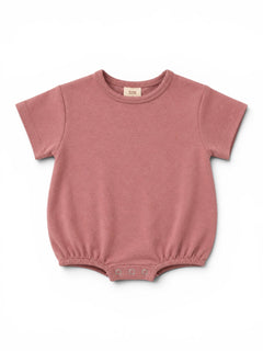 Pink baby bodysuit with short sleeves and snap closure at the bottom displayed on a white background.