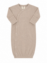 Light beige newborn sleep sack with ribbed texture and snap buttons, designed for comfort and ease of use.