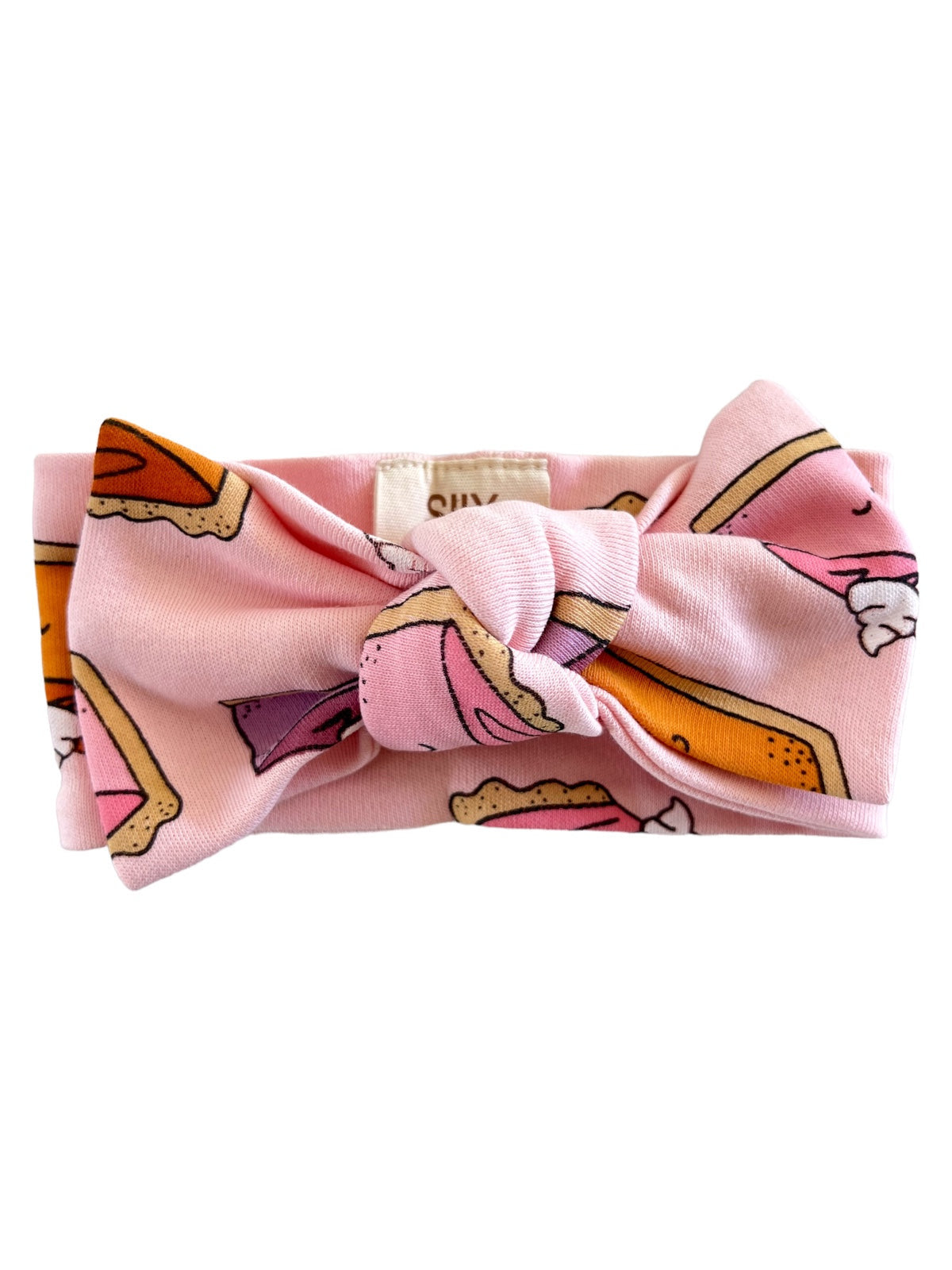 Pink headband with dessert prints, featuring ice cream cones and cake slices, tied in a knot.