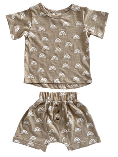 Beige children's outfit featuring white rainbow patterns, including a short-sleeve top and matching shorts.