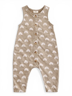 Tan romper with white rainbow patterns and wooden buttons, designed for infants.