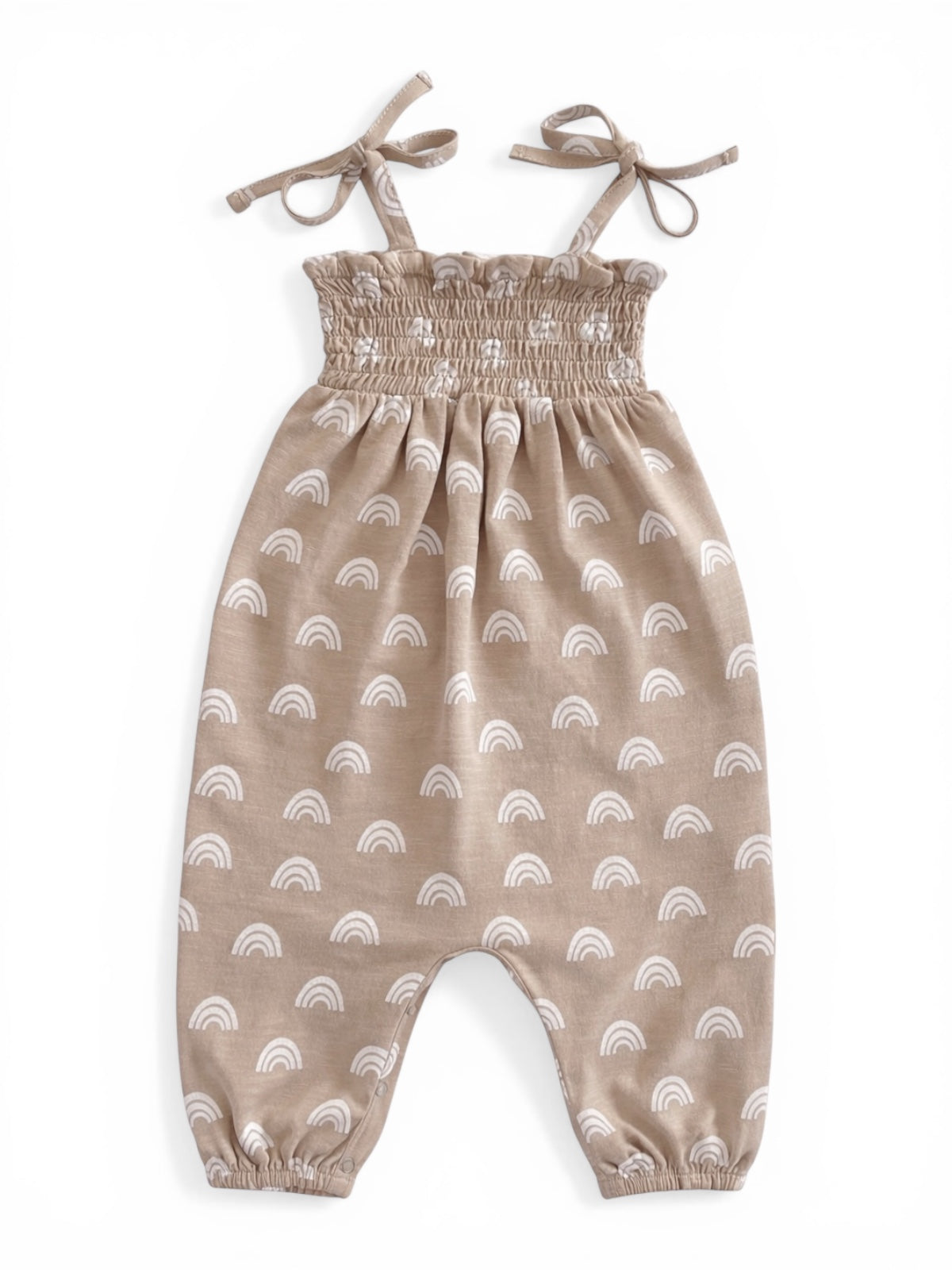 Light brown romper with white rainbow patterns, featuring adjustable straps and elasticized ankle cuffs.