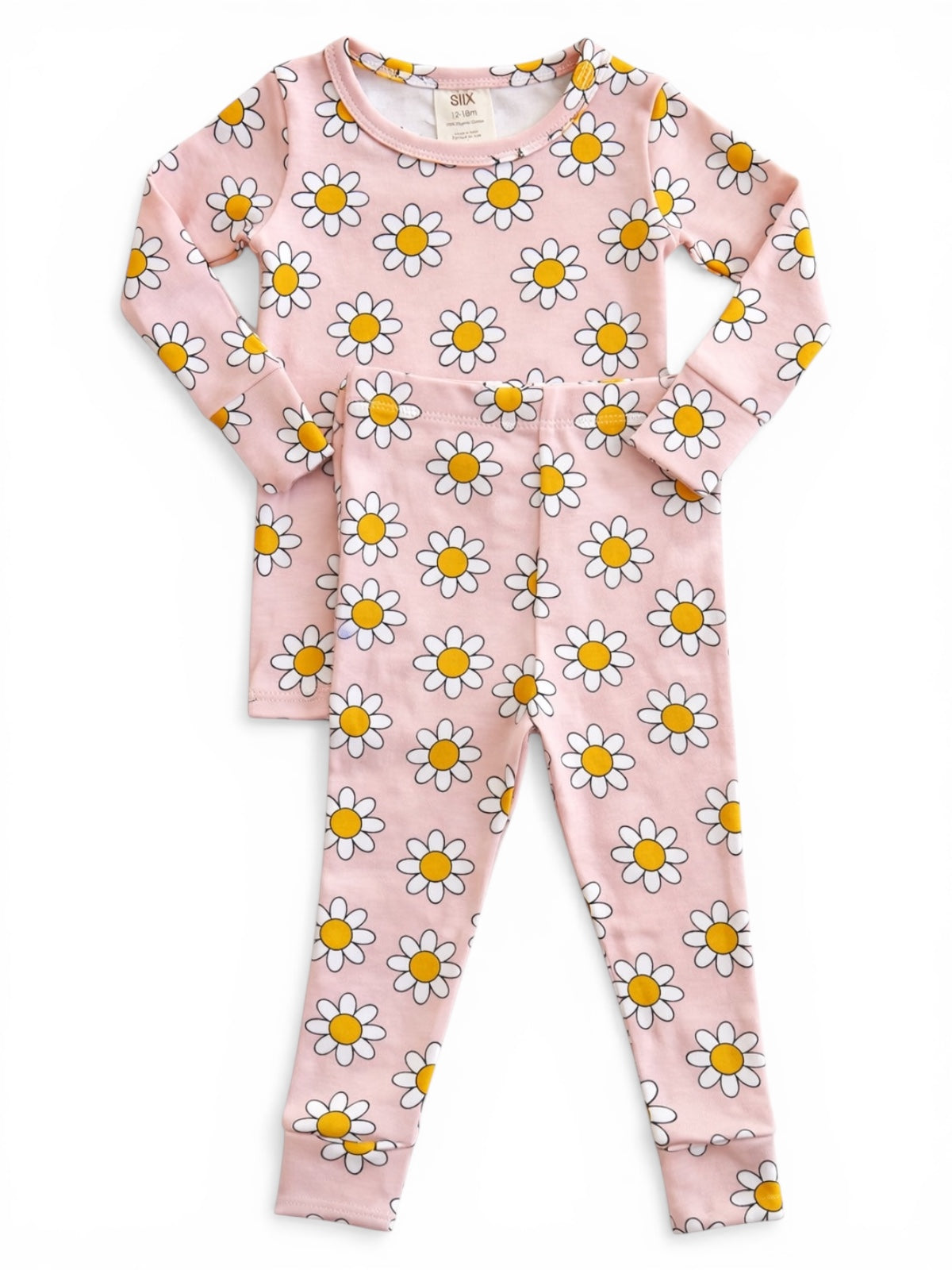 Pink pajama set with white daisies and yellow centers, featuring long sleeves and matching pants.