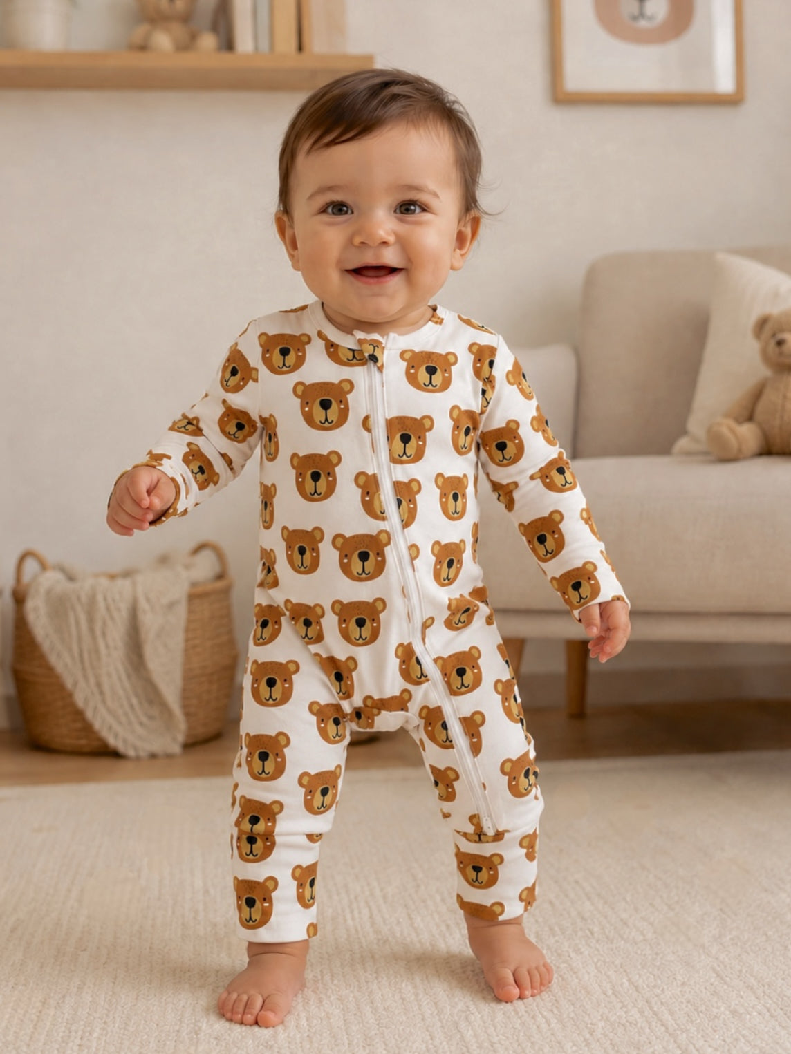 Smiling baby in bear-print onesie standing on a rug in a cozy, beautifully designed room.