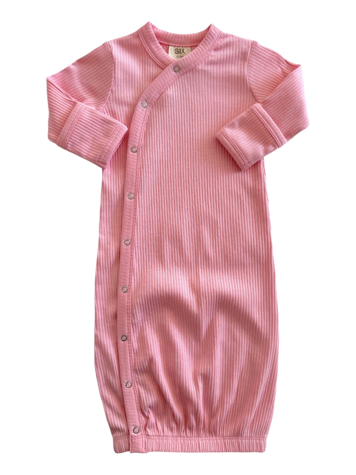 Pink ribbed cotton baby gown with long sleeves and snap buttons down the side. Ideal for comfort and easy dressing.